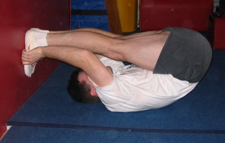 Inverted pike with feet against a wall in Pike Stretches Category